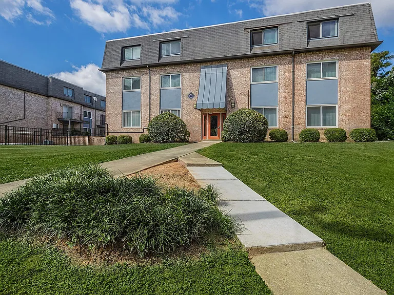 Experience the charm of this beautifully maintained apartment building, surrounded by vibrant greenery.