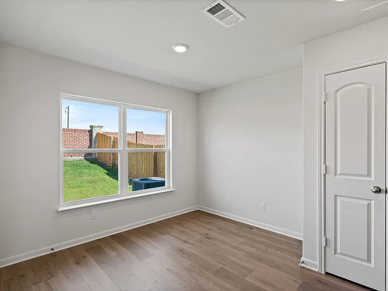 The dining room has a large window that lets in great, natural light and backyard views.