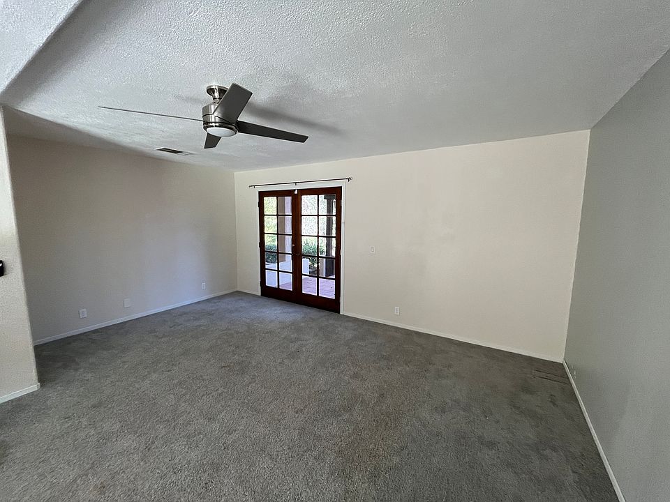 Livingroom with ceiling fan and french doors to front patio area.