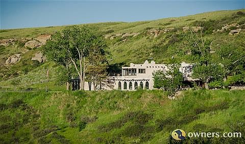 The house, protected by the bluff, sits well above the road