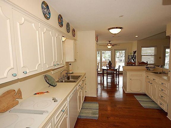 wood floors extend into the kitchen.