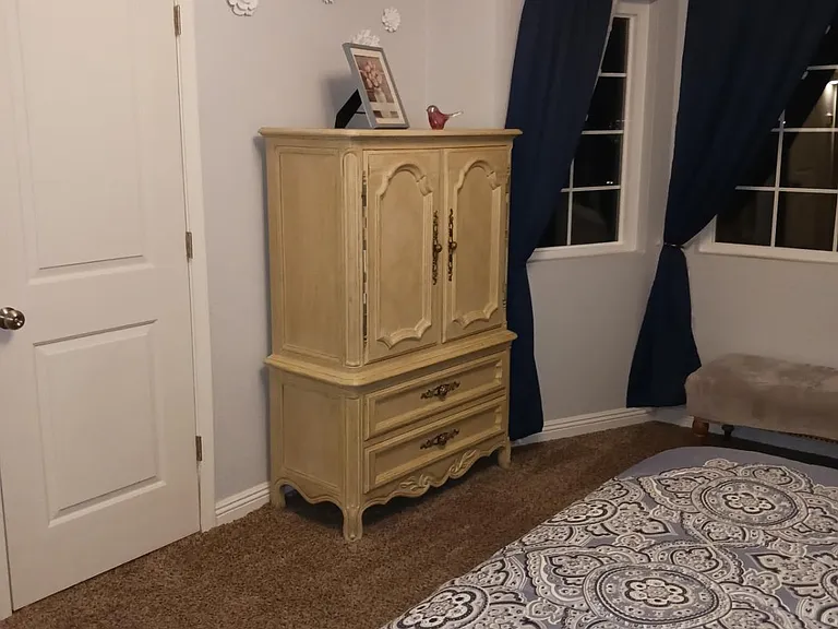 Master bedroom. Door next to armoire leads to walk in closet