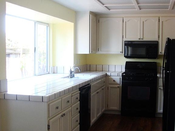 Kitchen with large window overlooking deck