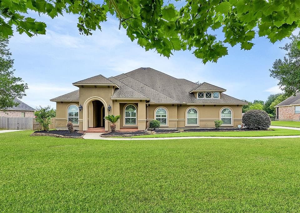 Beautiful home on One Acre Nicely set back from the street in A Gated Community.