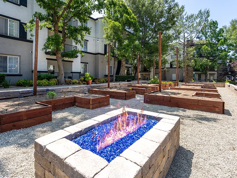 Community Gardening Space Featuring Built-In Fire Feature