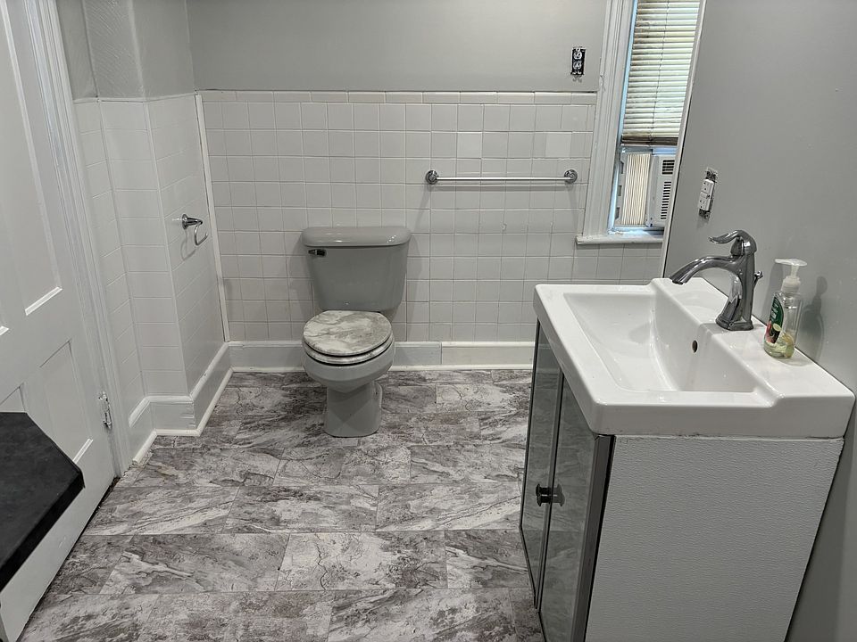 View from laundry area in bath of vanity/toilet. The window provides much natural light and fresh air.