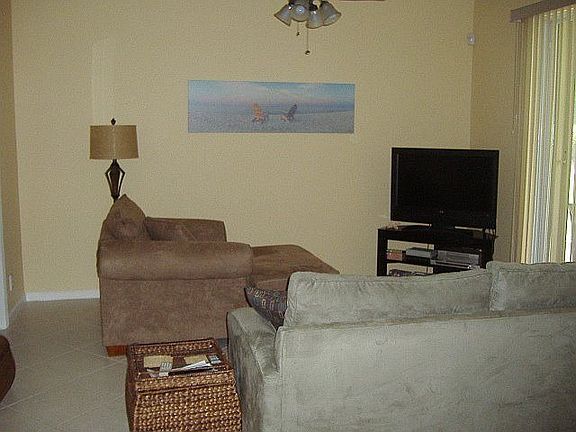 Family room with ceiling fan and dimmer lighting