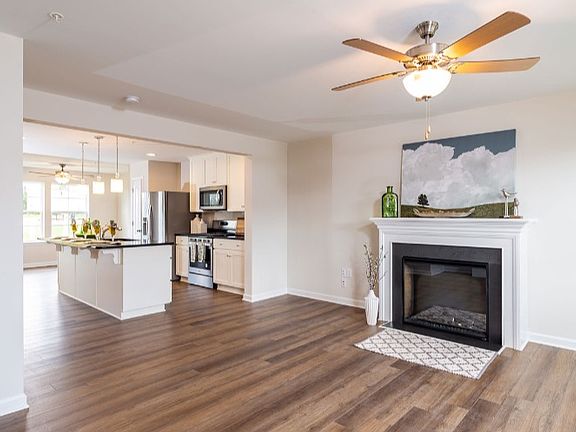 Living room with fireplace, beige walls and LVP flooring