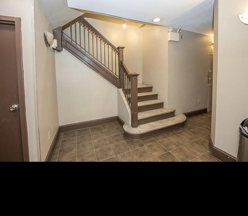 Main lobby stairwell for a quick walk up to unit #201. Basement door on the left for access down to laundry, trash and recycling or choose to take the elevator up or down to the basement.