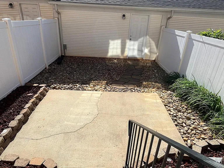 Privacy yard leading to garage.