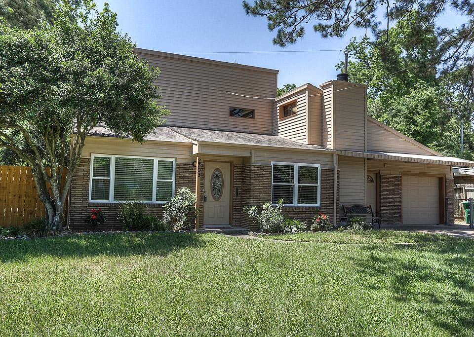 You will think you live in the country with all the large trees that surround the home. The four bed