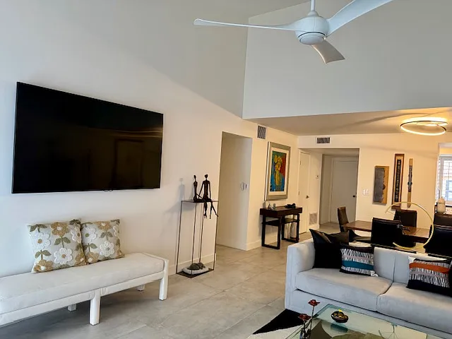 Living room area with smart tv looking toward front of home.