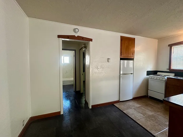 Living area and kitchen with hallway to bedroom and bathroom in back. Great layout!