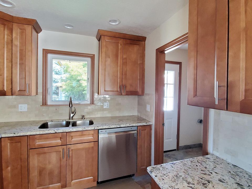 Large Kitchen with granite counters, new hardwood cabinets, stainless appliances including dishwasher.