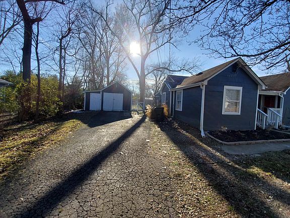 Long driveway and single car garage with storage area