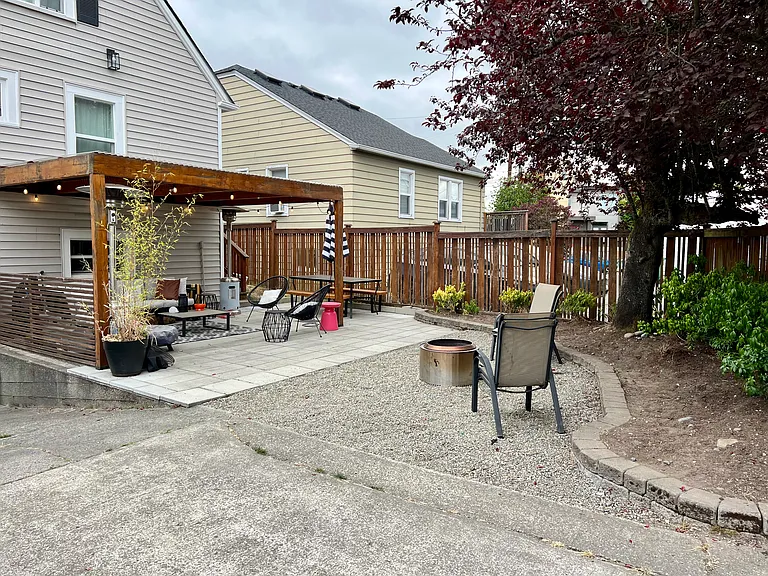 Covered pergola for entertaining outside with overhead lighting and hard plastic covering for year-round relaxing.