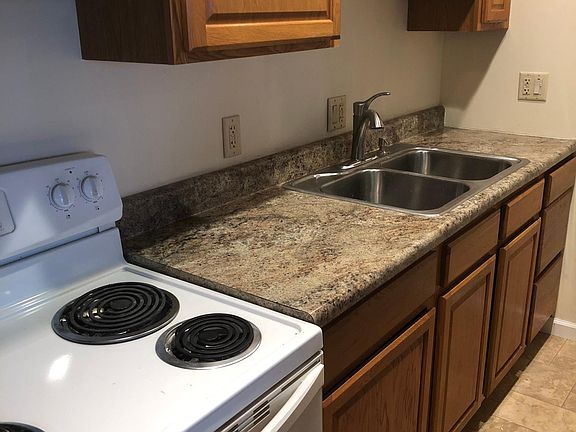 to the right is a breakfast bar with below cabinets
