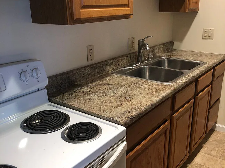 to the right is a breakfast bar with below cabinets