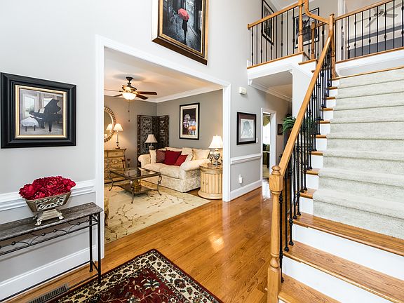 Dual staircases w/ wrought iron ballisters