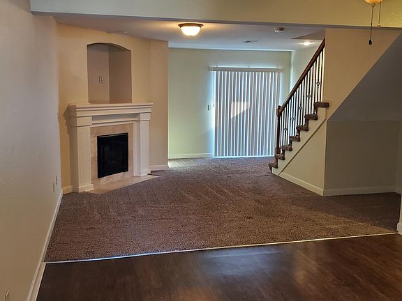 Living Room with Fireplace and Patio Door - 13637 Oak Valley - Oak Valley Rents