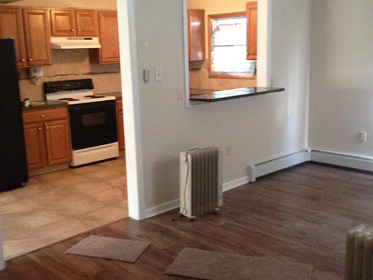 Den view of kitchen and pass-thru