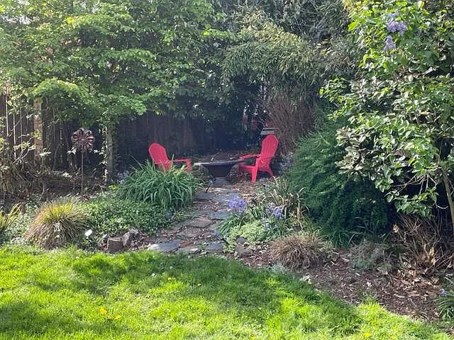 Fire pit in common area with adirondack chairs