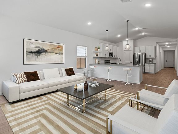 Great room, dining area, kitchen with soaring vaulted ceiling