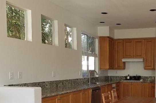 Kitchen - new granite counter top with many cabinets and windows