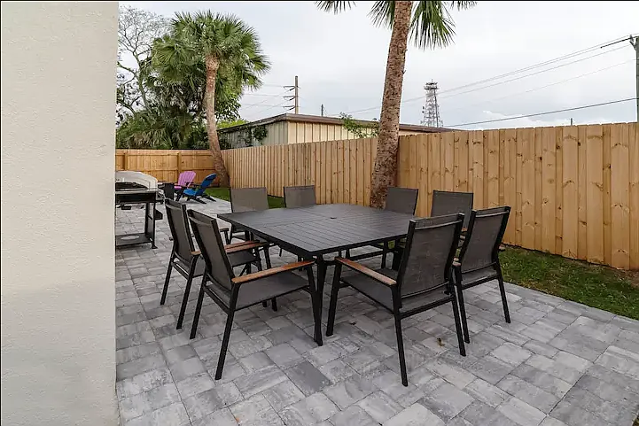 Patio table and chairs setting for eight for alfresco dining, perfect for enjoying meals in the Florida sunshine.