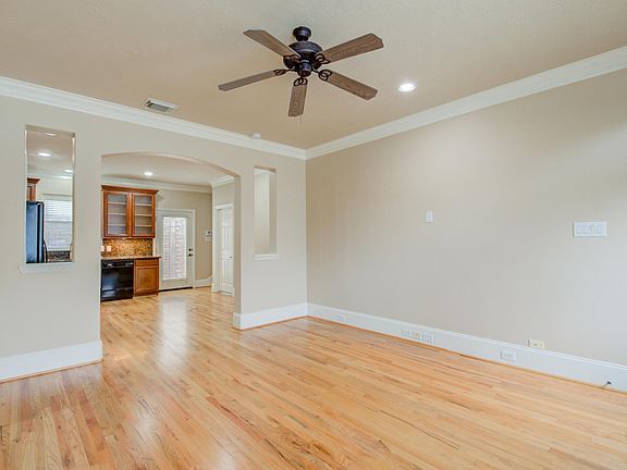 Living room looking into kitchen. *Picture does not reflect updated floors or kitchen cabinets.