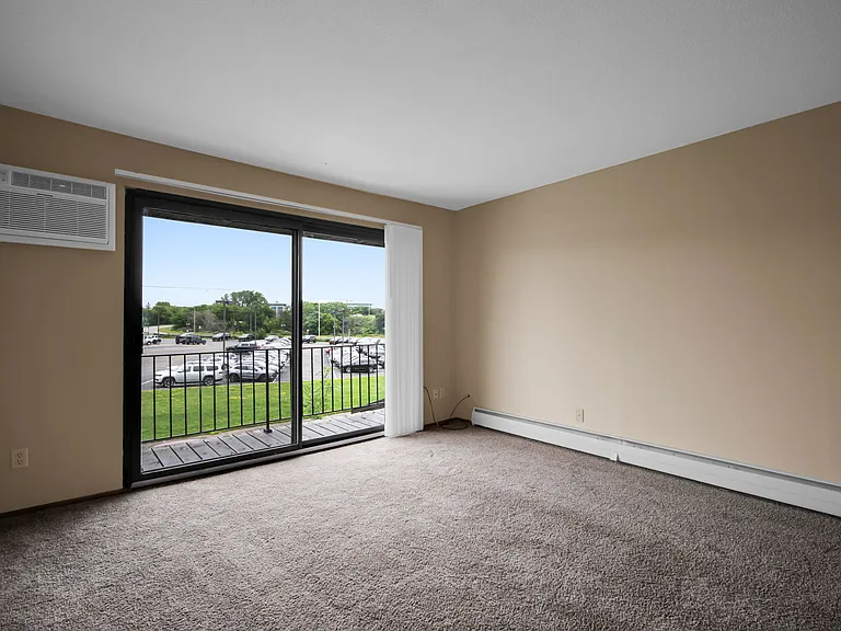 Living room with balcony and wall unit air conditioning