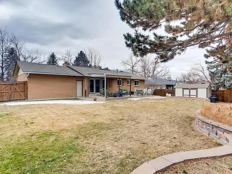Huge fenced backyard with storage shed, lawn equipment