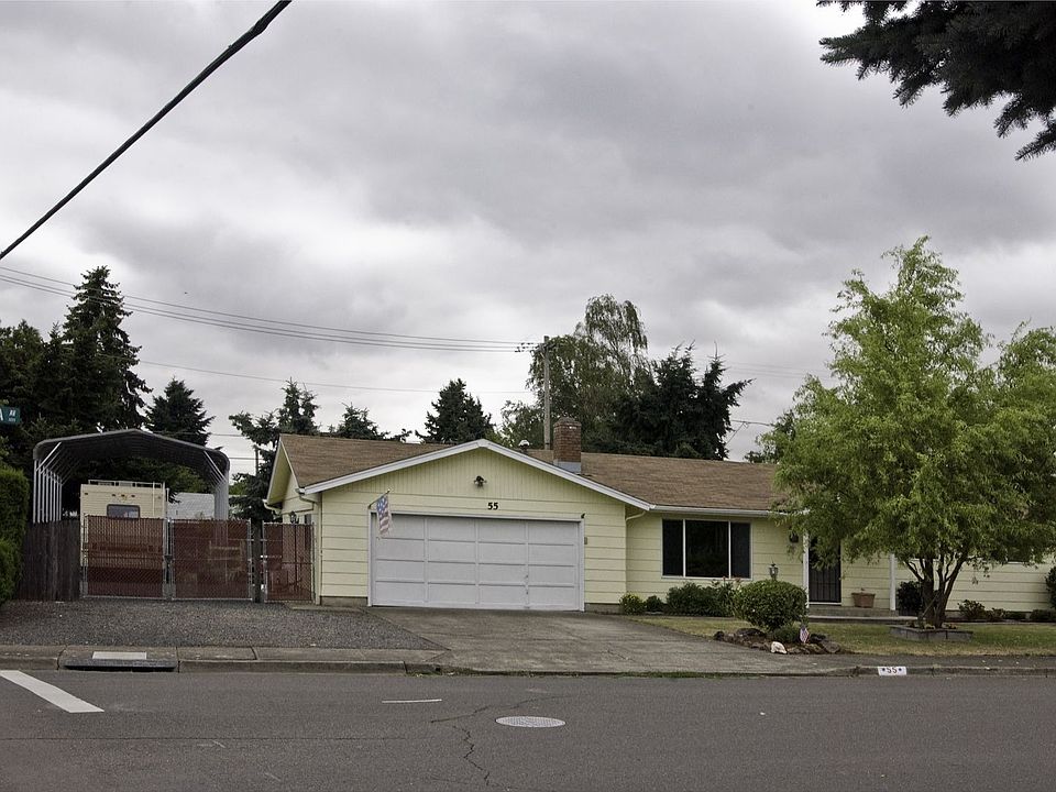 Front of house with gated covered RV parking