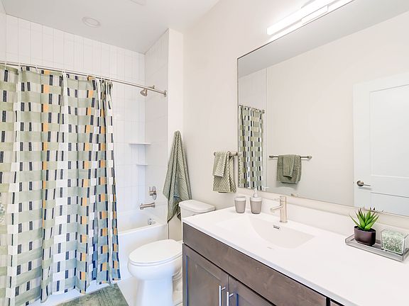 Primary Bathroom With Ceramic Tile Flooring & Bath Surround With Large Storage-Friendly Vanity