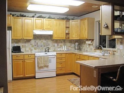 Kitchen
						:
						Custom old world stone w/glass inserts above glass top stove. Maple cabinets.