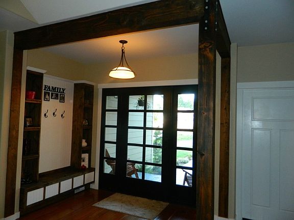 Gorgeous posts/beams in front entry. Frt dr will be different. Same built ins included, but stain color may change