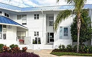 Exterior of Perico Bay Club first floor condo. Look closely, past the screen door and you can see through the dining room, through the living room and to the screened porch which looks out over the water where you can see fish jumping, muskrats playing a