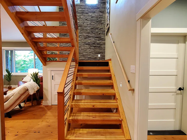 Glu-lam stairway leads to the 2nd floor where the bedrooms, laundry room and game room are located.