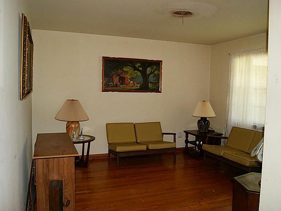 Enter to find the front living room, carpet removed to show the hardwoods