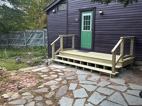 New front deck. Ready to welcome you! Laundry line conveniently right by the door. Courtyard, rock walls, firepit and granite steps to gardens.