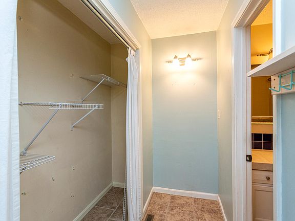 small hallway and closet leading to master bath