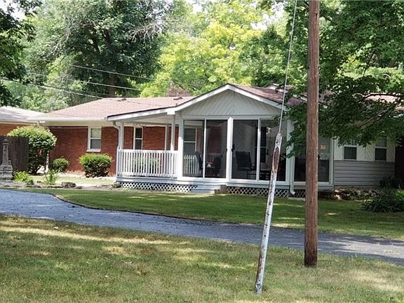 A view of the rear of the home with the enclosed patio and covered deck....AWESOME!