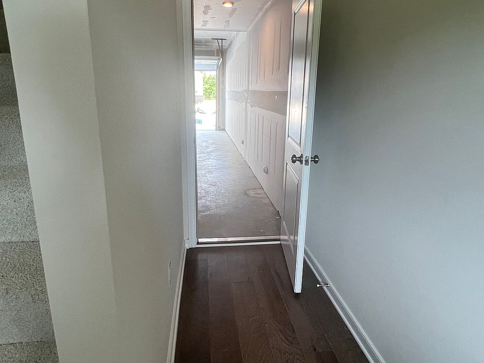 Entrance with wood floors (from garage)