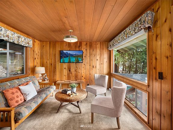Windows on both sides of the living room allowing light to pour in.