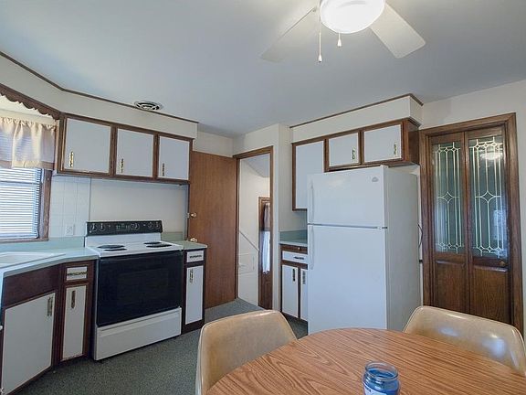 Eat-in-kitchen with access to exterior and basement.  This kitchen offers plenty of storage and room for everyday meals