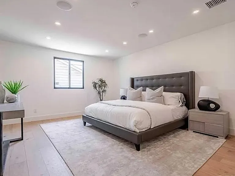 Suite-like master bedroom with built-in speakers and enough space for a reading nook or desk.