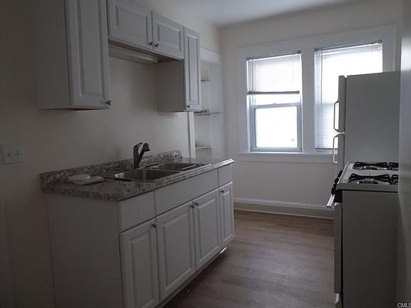 Kitchen w/new sink/counters & cabinets & flooring. Large pa