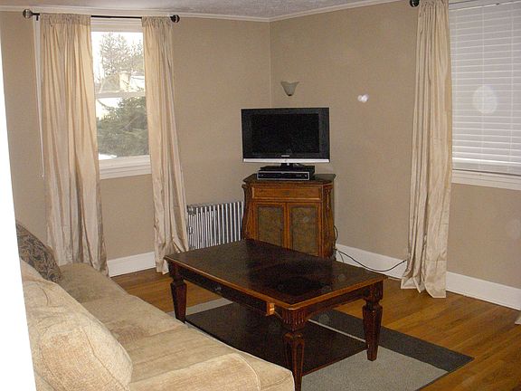 The airy family room has freshly painted walls and oak hardwoods 