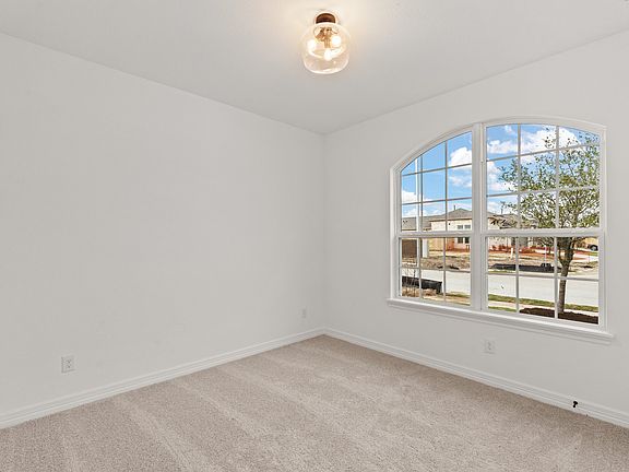 Your secondary bedroom features plush carpet, fresh paint, closet, and a large window that lets in p