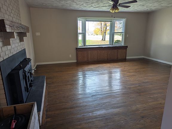 Living Room. Bay window seat with storage underneath. Wood stove for alternate heat.